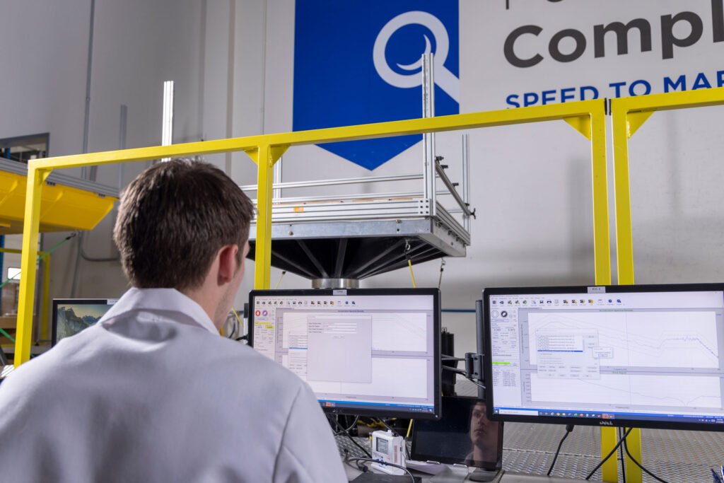 Person in labcoat at computer