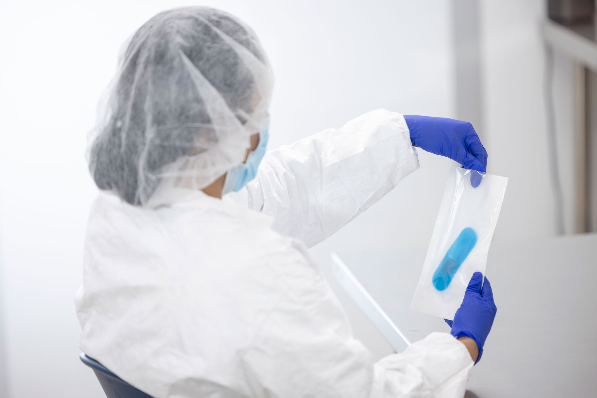 PCL employee holding a sample pouch