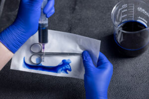 Expert performing a dye leak test on a pouch.
