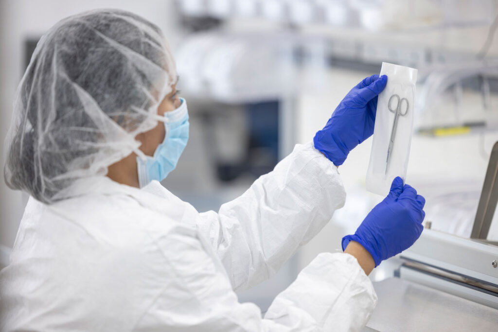 Lab tech holding a medical device in a pouch