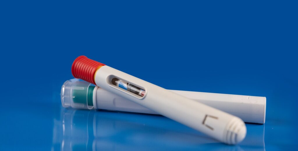 Autoinjectors in front of blue background